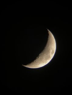 the moon is seen in the dark sky with only one light on it's side