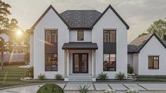 a white two story house with black trim