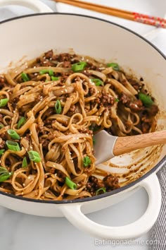 a skillet filled with noodles and ground beef