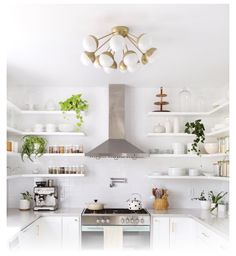 a kitchen with white cabinets and open shelving