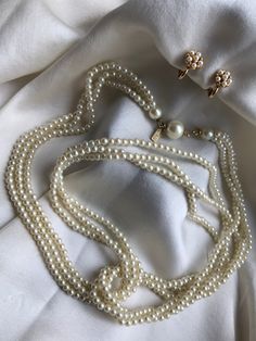 Vintage necklace by Marvella and miniature clip earrings.  1)Delicate three-row necklace made of cream colored faux pearls, 50's style. The pearls are small in size -3 mm. Color of pearls: creamy shade (without yellowing). The beads are light, beautiful nacre and with a large pearl clasp.   The necklace is accompanied by small   clip earrings. They are signed on the Patented lug. Have quality gold plating and pearls. Designed for a small earlobe! The clip is very high quality and works great. Ea Vintage White Pearl Clip-on Earrings, Vintage Multi-strand Pearl Jewelry, Vintage Pearls Aesthetic, Peral Necklace, Pearls Aesthetic, Vintage Pearl Necklace, Pearl Clasp, Pearl Necklace Vintage, 50's Style