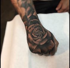 a man with a rose tattoo on his hand