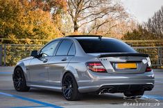 the rear end of a silver mercedes c - class car parked in a parking lot