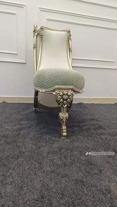 a white chair sitting on top of a gray carpet