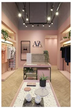 the interior of a clothing store with pink walls