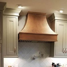 a stove top oven sitting inside of a kitchen next to white counter tops and cabinets