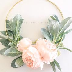 a wreath with flowers and greenery on it