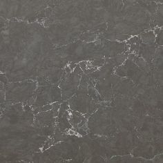 a black marble textured wallpaper with white and gray streaks on the top right hand corner