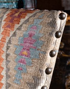 a close up of a pillow with buttons on it