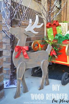 a wooden reindeer with red bows on its antlers