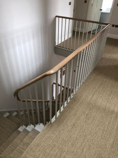 a stair case in an empty room with carpeting on the floor and door to another room