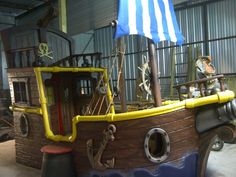 an old pirate ship replica in a warehouse