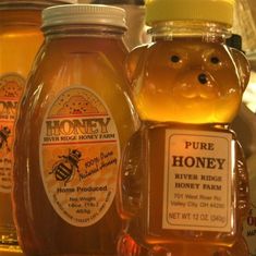 several jars of honey sit on a shelf