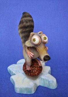 a figurine of a squirrel on top of an ice flake with eyes wide open