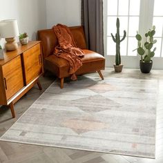 a living room with a couch, chair and rug