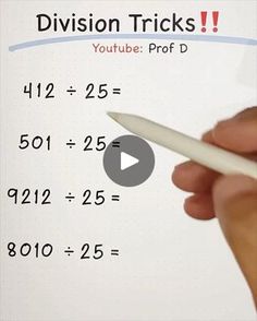 a hand holding a pen writing on a whiteboard with the word division tricks below it