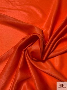 an orange satin fabric with very thin folds