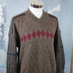 "This 1980s Italian vintage sweater is a warm brown color with a burgundy argyle pattern across the front and back and accented with black fine striping. The wool-mohair blend pullover has a short V neckline with a wide ribbed crossover collar. The sweater has ribbed cuffs and a ribbed waistband. Note that this is a \"short\" size. See especially the sleeve length and sweater length below. Brand label: Nani Bon Size: 46S (US/UK) Material: 40% acrylic, 30% wool, 20% mohair, 10% nylon Chest = 46 i Lumberjack Style, Steampunk Jacket, Random Clothes, Pullover Sweater Men, Argyle Pattern, Pullover Outfit, Sweater Brown, Vintage Clothing Men, Vintage Clothing Online