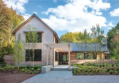 a large house with lots of windows and landscaping