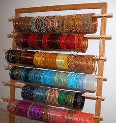 a rack with many different colored bracelets on it