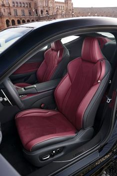 the interior of a car is shown with red leather and black trims on it
