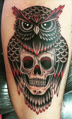 an owl and skull tattoo on the leg