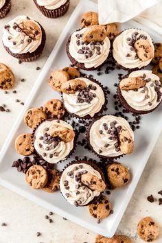 chocolate chip cupcakes with white frosting and cookies on a plate next to them