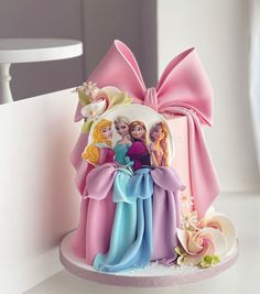 there is a cake decorated with princesses on it