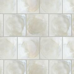 a white tile wall with an abstract design