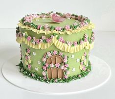 a green cake with pink flowers on it