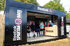 a group of people standing inside of a booth