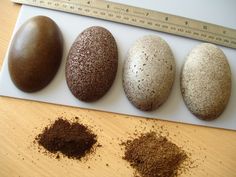 four different types of rocks on a table with a measuring tape in front of them