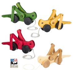 four wooden toy cars are shown in three different colors and shapes, one is red, one is green, the other is yellow