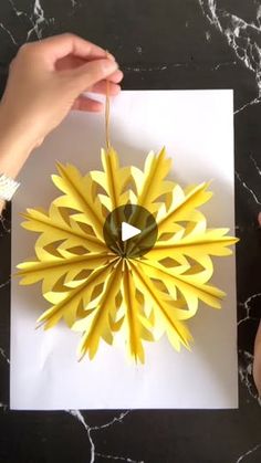 someone is making a flower out of paper