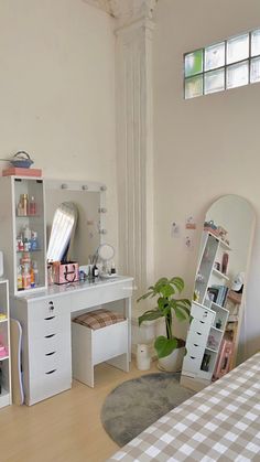 a bedroom with a bed, desk and mirror