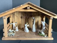 a wooden nativity scene with figurines in it