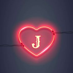 a heart shaped neon sign with the letter j on it