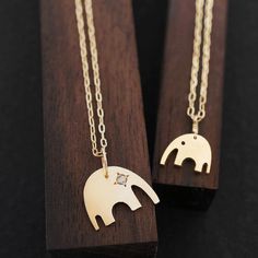 Delicate Timeless and Cute Elephant Necklace Set of 2 Elephant mother daughter matching necklaces of AF HOUSE is the simplest yet elegant and cute and a perfect gift to celebrate the mom and daughter bond, or even best friends'. With the option to add a lucky diamond to the animal's eye, this necklace is sure to make her smile. Ideal for Push present, Mother's day, and Family anniversaries Solid 14K Gold or Sterling Silver with Diamond Mother elephant 1/2”w Baby elephant 5/16"w Diamond 0.005 Ct Mom And Daughter Bond, Mother Daughter Necklaces, Mother Elephant, Gift Guide Design, Mother Daughter Necklaces Set, Punk Love, Push Present, Necklaces Set, Mother Daughter Necklace