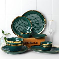 green and gold dinnerware set on display