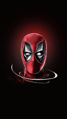 a deadpool mask is shown in the dark with red light coming from its eyes