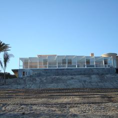 a large building sitting on top of a sandy beach