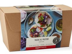 an open box of tacos al pastora