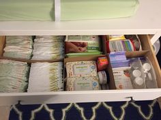 an open drawer filled with diapers and other items