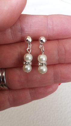 "Dainty Pearl Earrings. Can be either clip on or stud backed Wedding Pearl Earrings made with 6mm Ivory Pearl Beads ( If you would prefer a different colour then please message me) Total length is 2.5cm / 1\" Perfect for wedding jewellery or a gift for your loved ones or for yourself. Comes in a complimentary organza pouch Any questions feel free to ask. Thank you for looking Further items in my shop etsy.com/uk/shop/JansGems2012" Wedding Pearl Earrings, Dainty Pearl Earrings, Pearls Wedding, Pearl Earrings Wedding, Organza Pouch, Earrings Bridesmaid, Etsy Bridesmaid Gifts, Ivory Pearl, Earrings Dainty