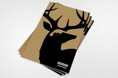 a stack of brown and black paper with an image of a deer's head