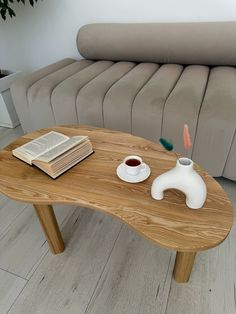 a coffee table with a book and cup on it