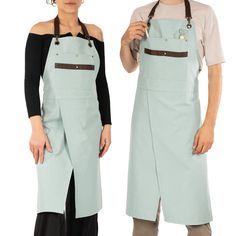 two people standing next to each other wearing aprons