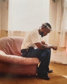 a man sitting on top of a pink couch