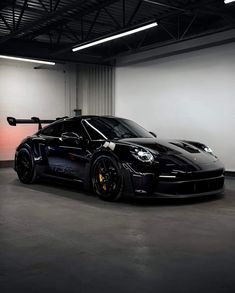 a black sports car parked in a garage