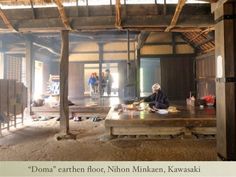 a person sitting at a table in an old building